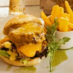 the orchards farmstall shows you how to cook the perfect burger on a plate with fries
