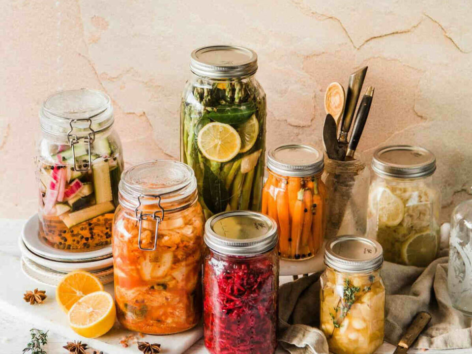 glass jars with fermenting fruit and vegetable pieces