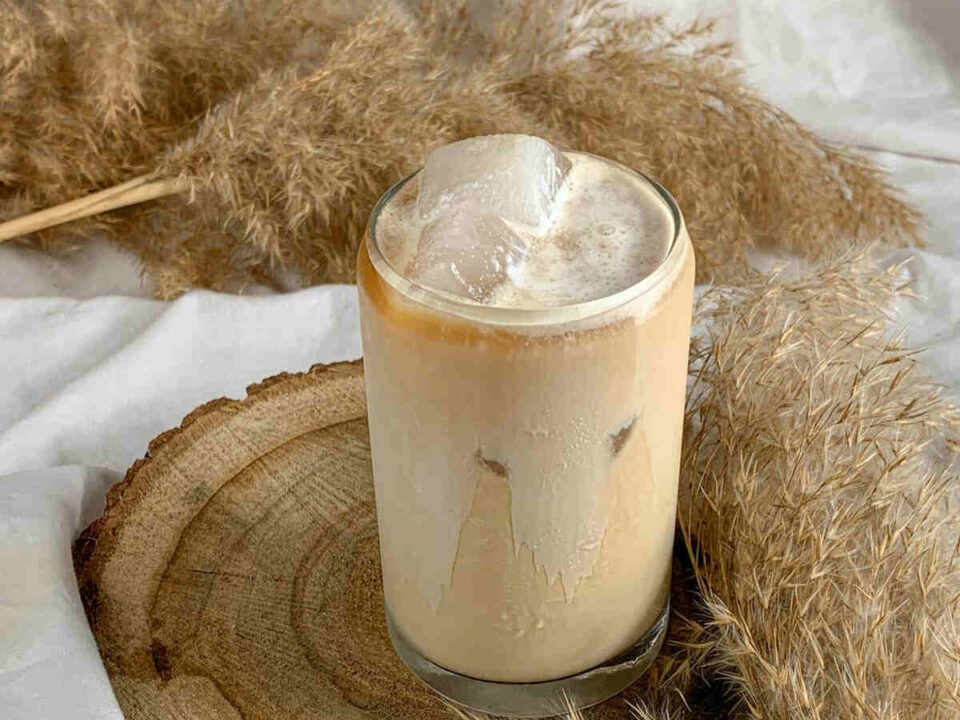 illustrating Summer on Ice with a glass of creamy iced coffee with artistic background