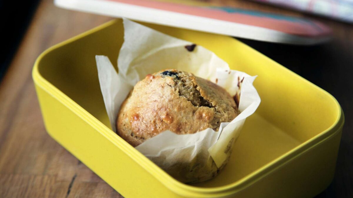 A yellow Back-to-School Lunchbox with a small muffin