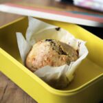 A yellow Back-to-School Lunchbox with a small muffin
