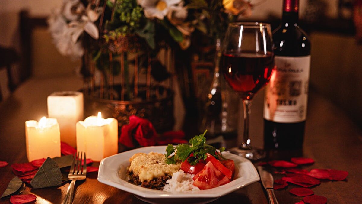 Valentine's day dinner at home with candlelight rose petals and wine