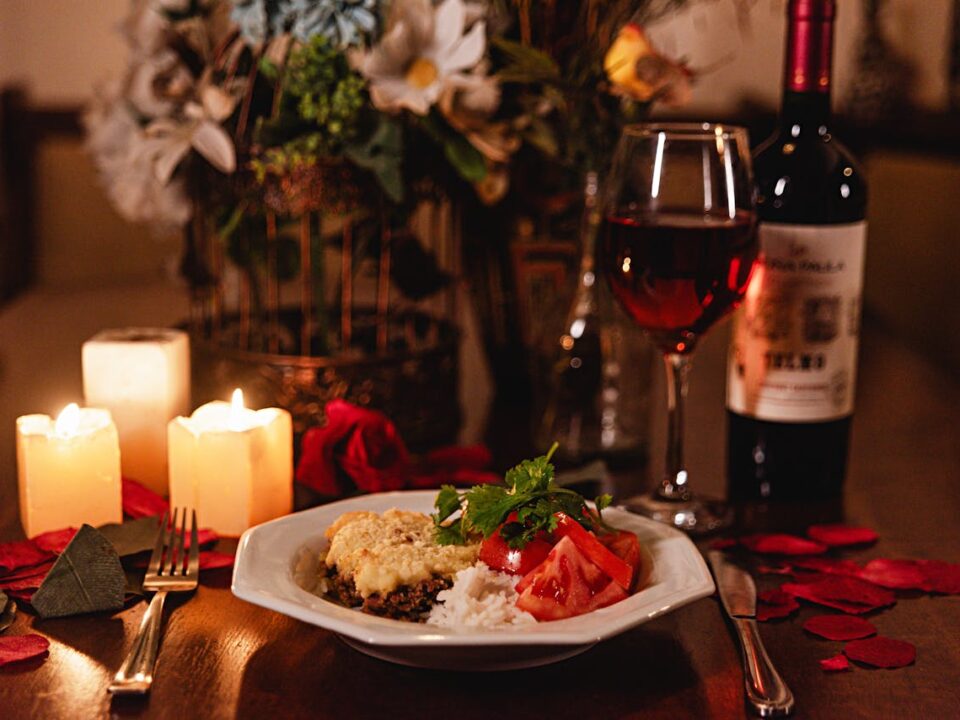 Valentine's day dinner at home with candlelight rose petals and wine