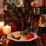 Valentine's day dinner at home with candlelight rose petals and wine