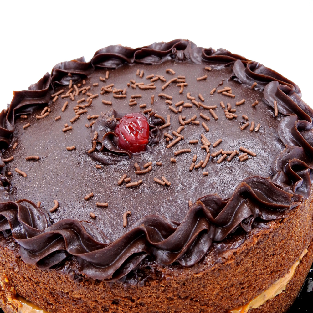 A decadent chocolate cake displayed on a serving plate, showing its soft layers and dark chocolate richness, crafted for a truly indulgent dessert moment.