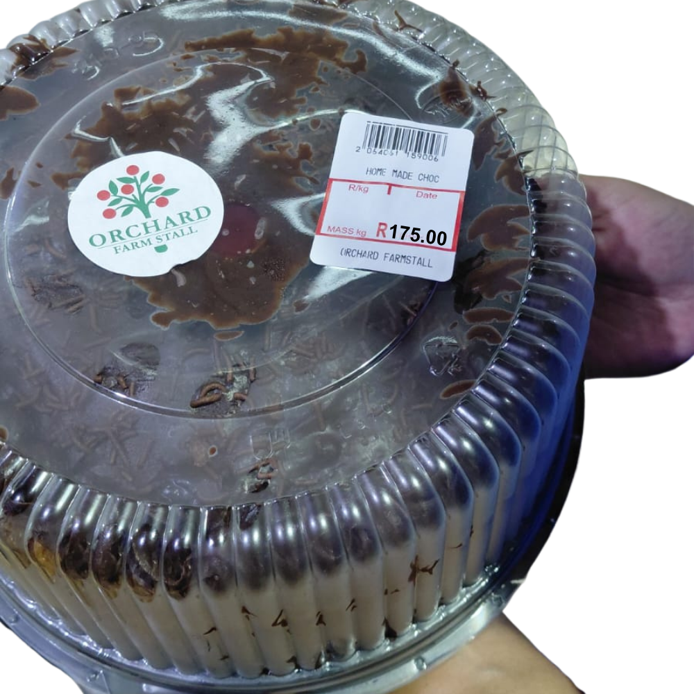 A beautifully presented chocolate cake with a rich cocoa tone and light, airy interior, showcasing a comforting homemade dessert perfect for celebrations or treats.In packaging.