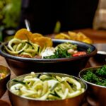 A variety of easy side dishes that steal the show at any meal, including roasted potatoes, fresh salad, and sautéed vegetables on a shared table.