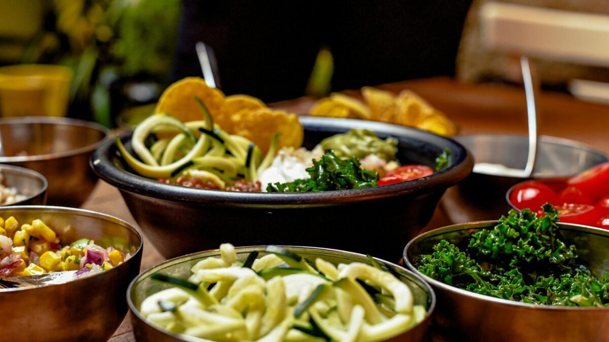 A variety of easy side dishes that steal the show at any meal, including roasted potatoes, fresh salad, and sautéed vegetables on a shared table.