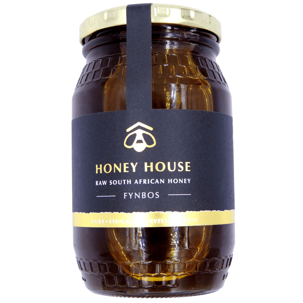 Honey House Pure Honey in a clear jar, showing its smooth golden colour and natural clarity, highlighting the rich, floral sweetness and velvety texture ideal for drizzling, stirring into tea, or everyday cooking.