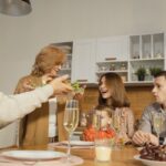 Multiple generations of a family sharing a meal around a dining table.