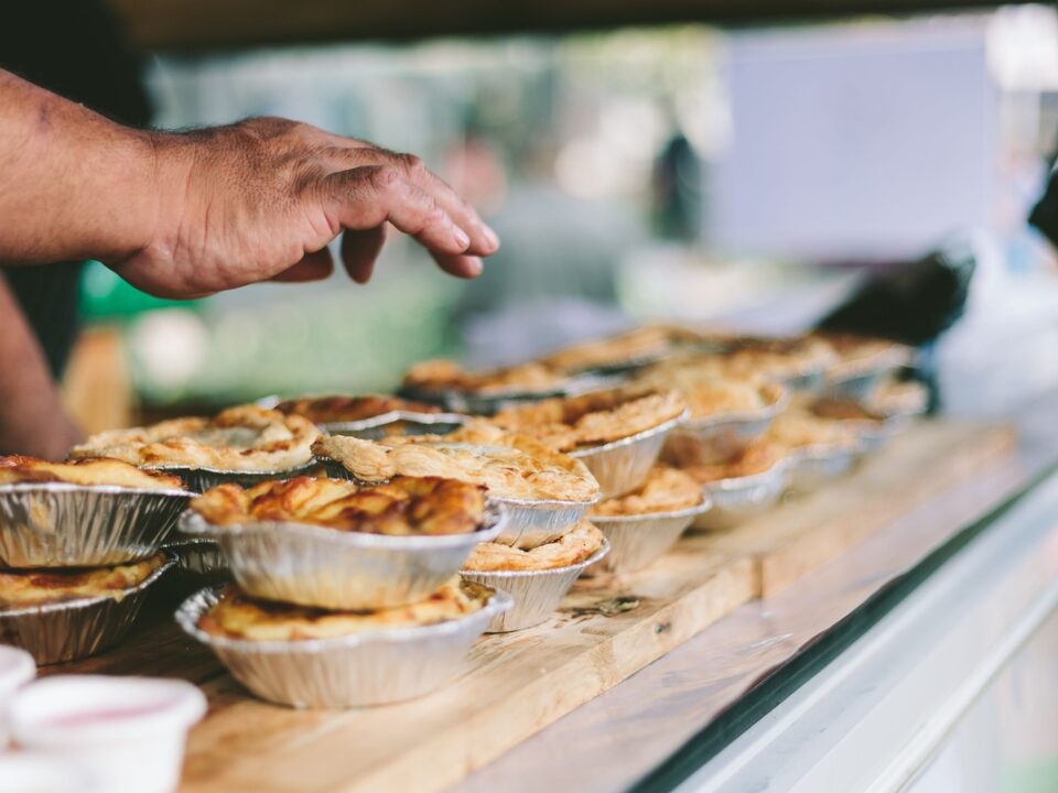 Best Farm Stall Stop showcasing baked pies on wooden counter