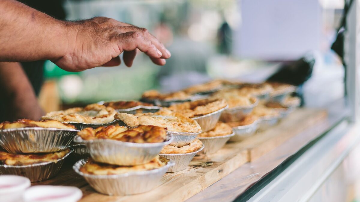 Best Farm Stall Stop showcasing baked pies on wooden counter