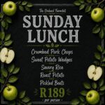 Family enjoying Sunday lunch at The Orchard Farm Stall with homemade food, fresh baking, outdoor seating, and a children's play area.